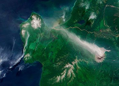 The Shiveluch Volcano in northeast Russia expelling a stream of aerosols into atmosphere. Courtesy of NASA Earth Observatory.