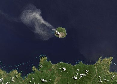 Volcano Paluweh on the small island of Palu'e in East Nusa Tenggara, Indonesia spewing gases into the air. Courtesy of NASA Earth Observatory.